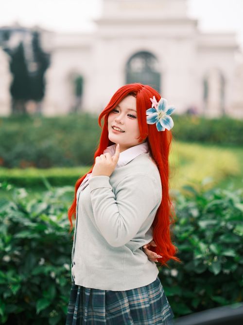 Free Cosplay enthusiast poses with a flower in a picturesque Vietnamese garden. Stock Photo