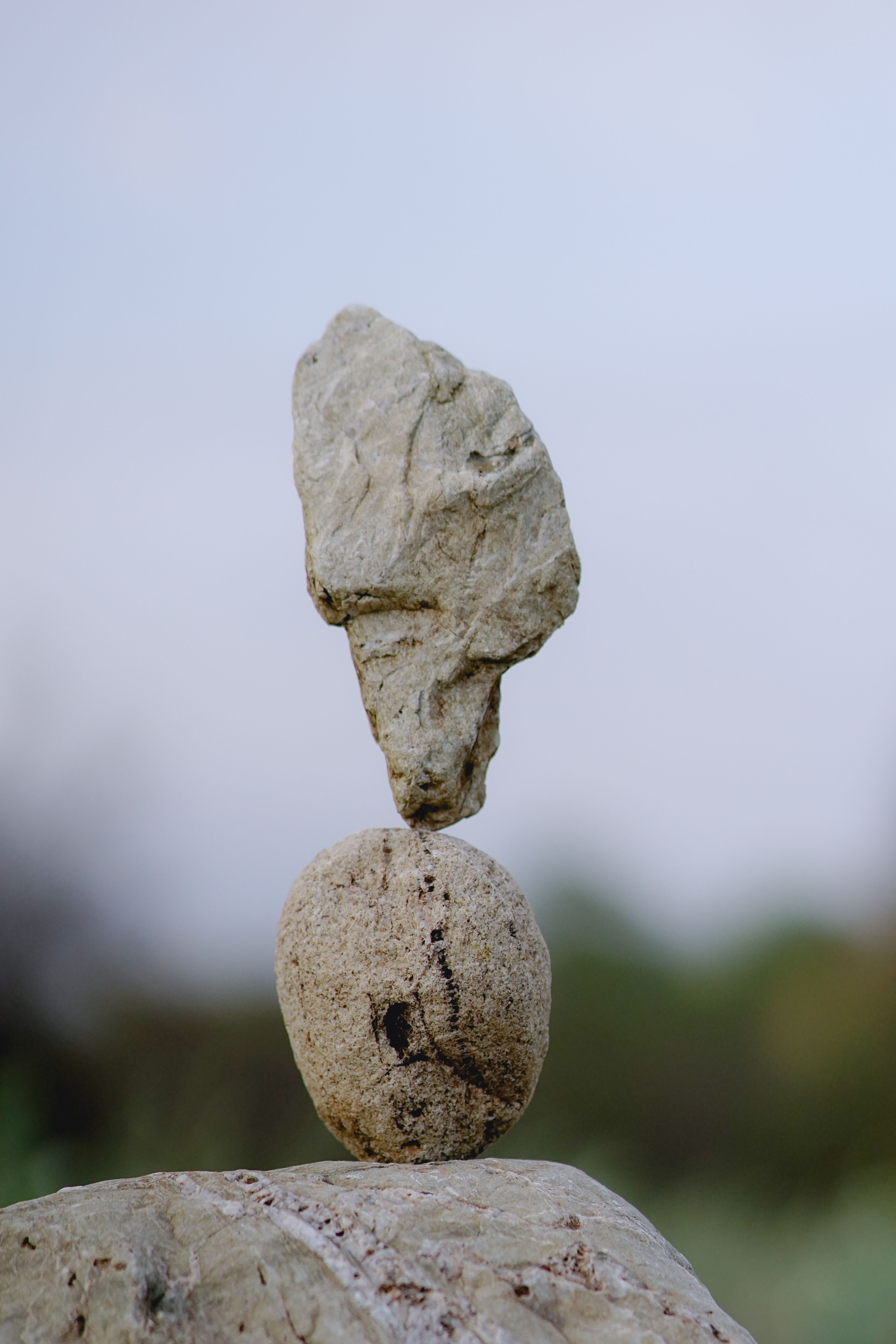 Two stones perfectly balanced in a natural outdoor setting, showcasing harmony and stability.