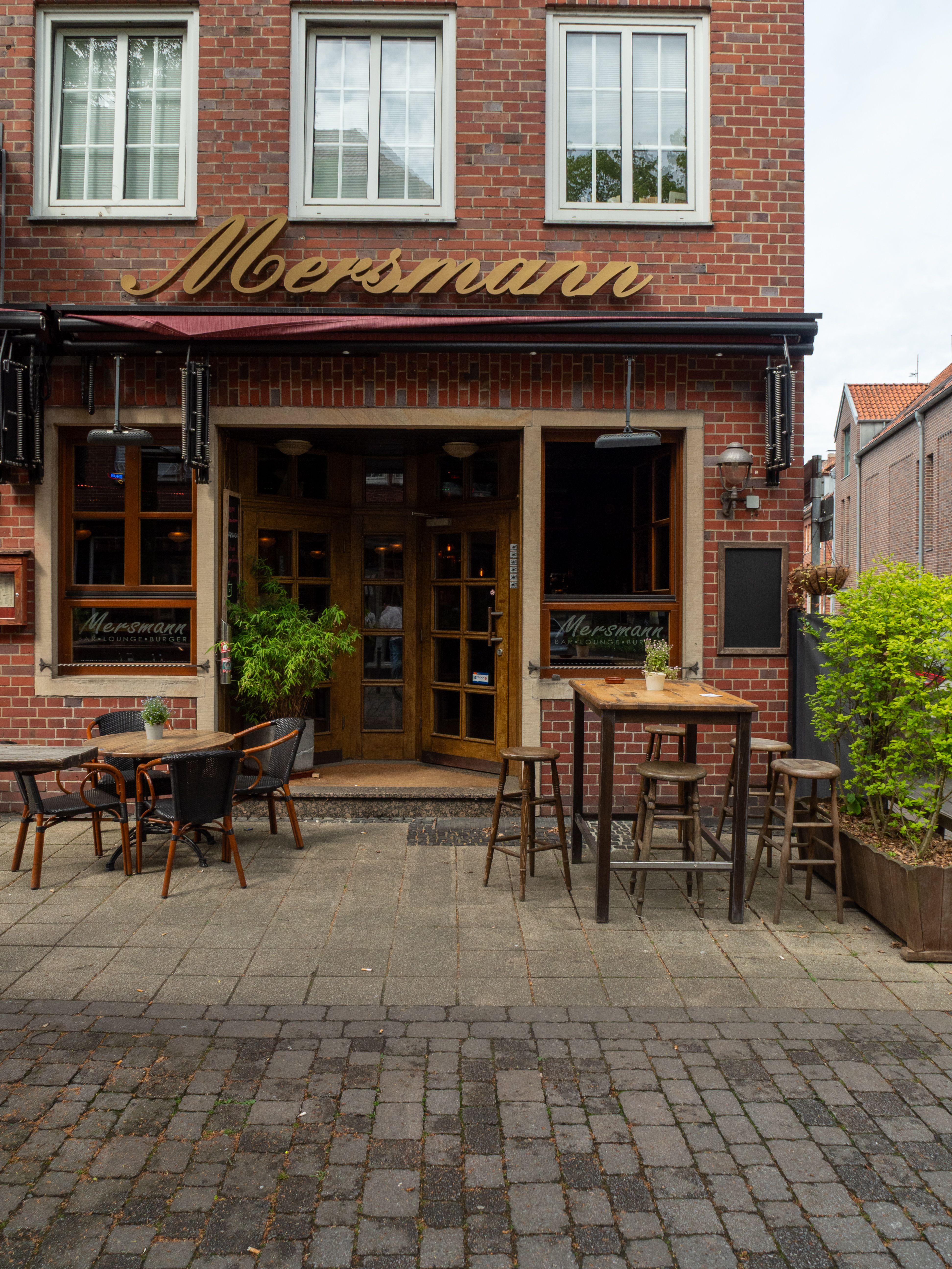Inviting exterior of Mersmann cafe restaurant in Coesfeld, Germany, featuring outdoor seating.
