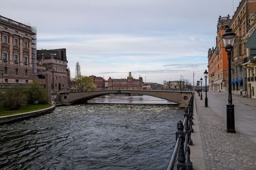 Free A scenic view of a historic bridge over a river in Stockholm, Sweden, with classic architecture. Stock Photo