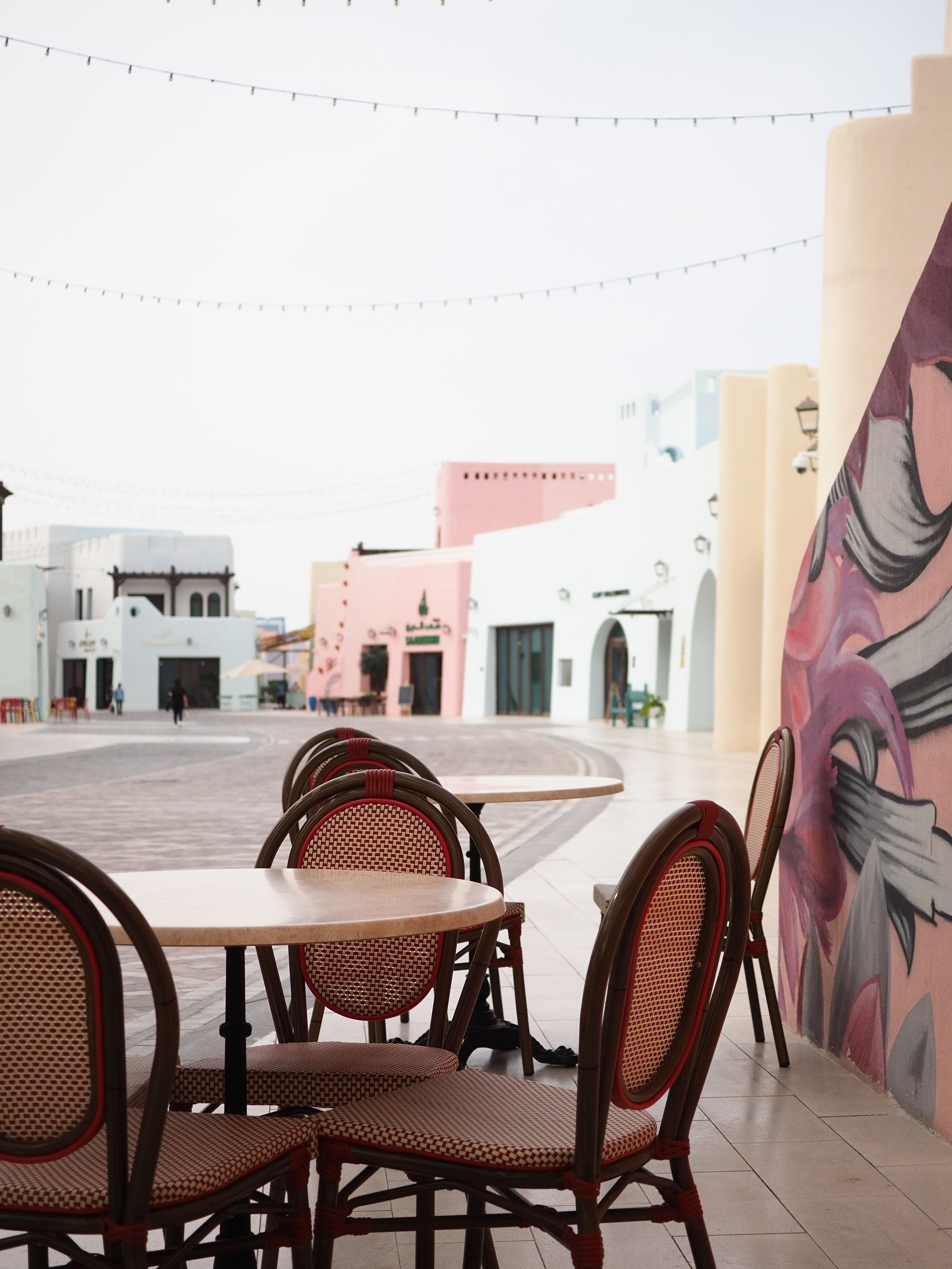 Charming Outdoor Cafe in Colorful Doha Street · Free Stock Photo