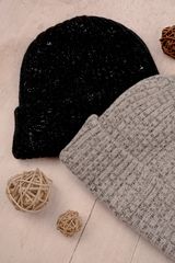 Knitted wool caps on a wooden surface, photo by Lee Hanson on Pexels