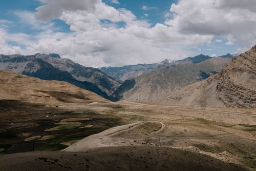 Free Dramatic landscape of Spiti Valley with rugged mountains and cloudy sky, ideal for adventure travel. Stock Photo