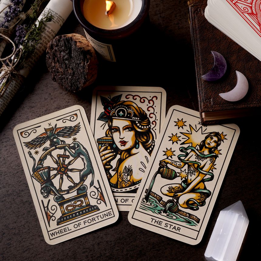 Oracle cards, a lit candle and crystals in a dark setting — Natalie Goodwin on Pexels