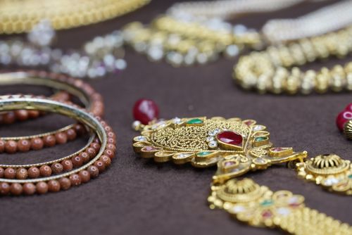 Free Stunning close-up of intricately designed gold and beaded jewelry showcasing traditional craftsmanship. Stock Photo