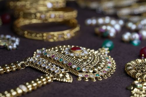 Free Close-up of traditional Indian gold jewelry with intricate design, featuring gems and pearls. Stock Photo