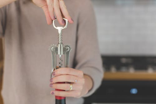 Person Holding Grey and Red Hand Tool