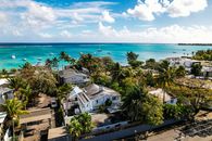 Breathtaking aerial view of Trou aux Biches' turquoise waters and coastal homes in Mauritius.