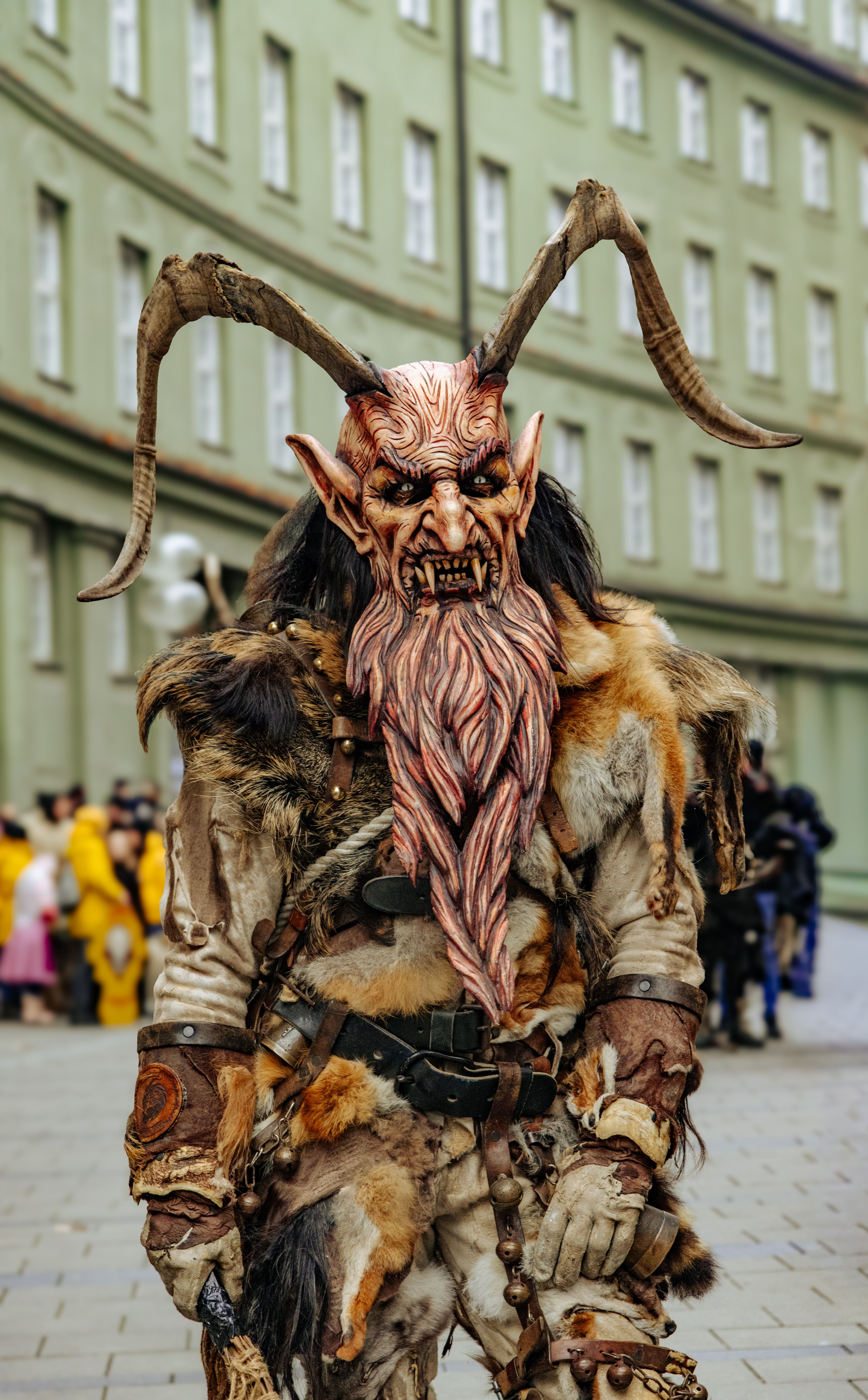 Colorful Krampus monster costume at a traditional parade in Munich, Germany.