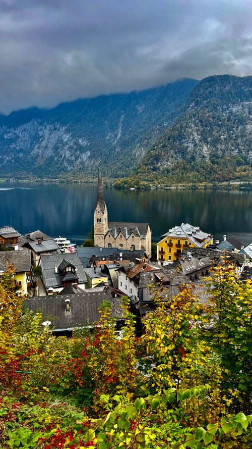 Free A stunning autumn view of Hallstatt village with mountains, lake, and colorful foliage in Austria. Stock Photo