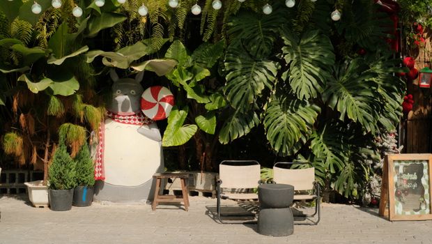 Outdoor scene with a whimsical statue and lush greenery, perfect for relaxation.