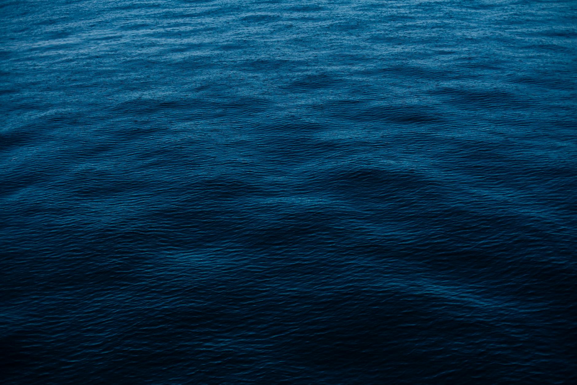 Vivid depiction of deep blue ocean surface, perfect for backgrounds and wallpapers.