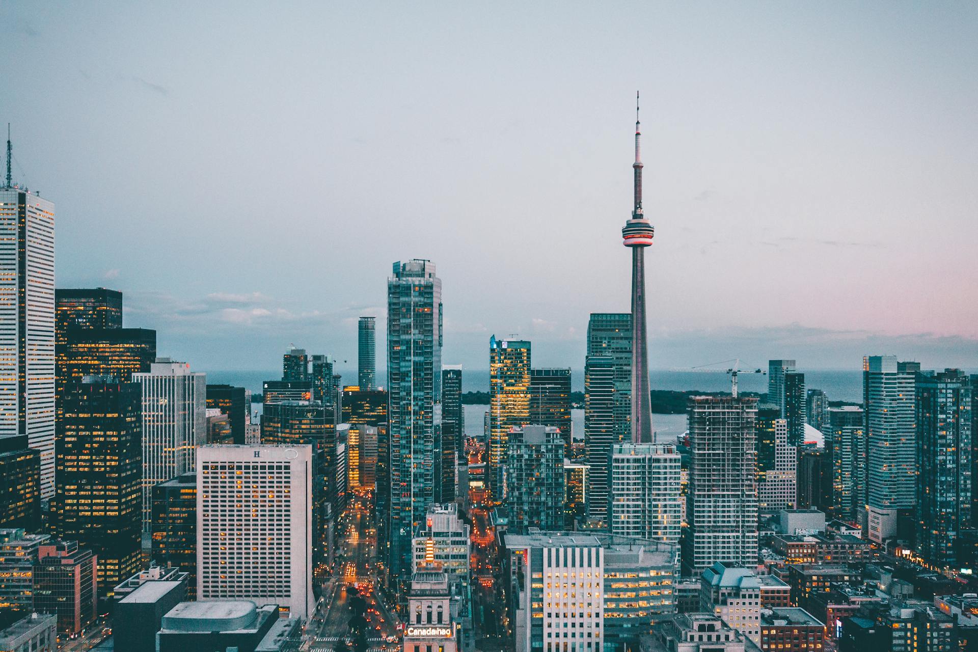 A breathtaking view of Toronto's skyline featuring the iconic CN Tower at dusk.