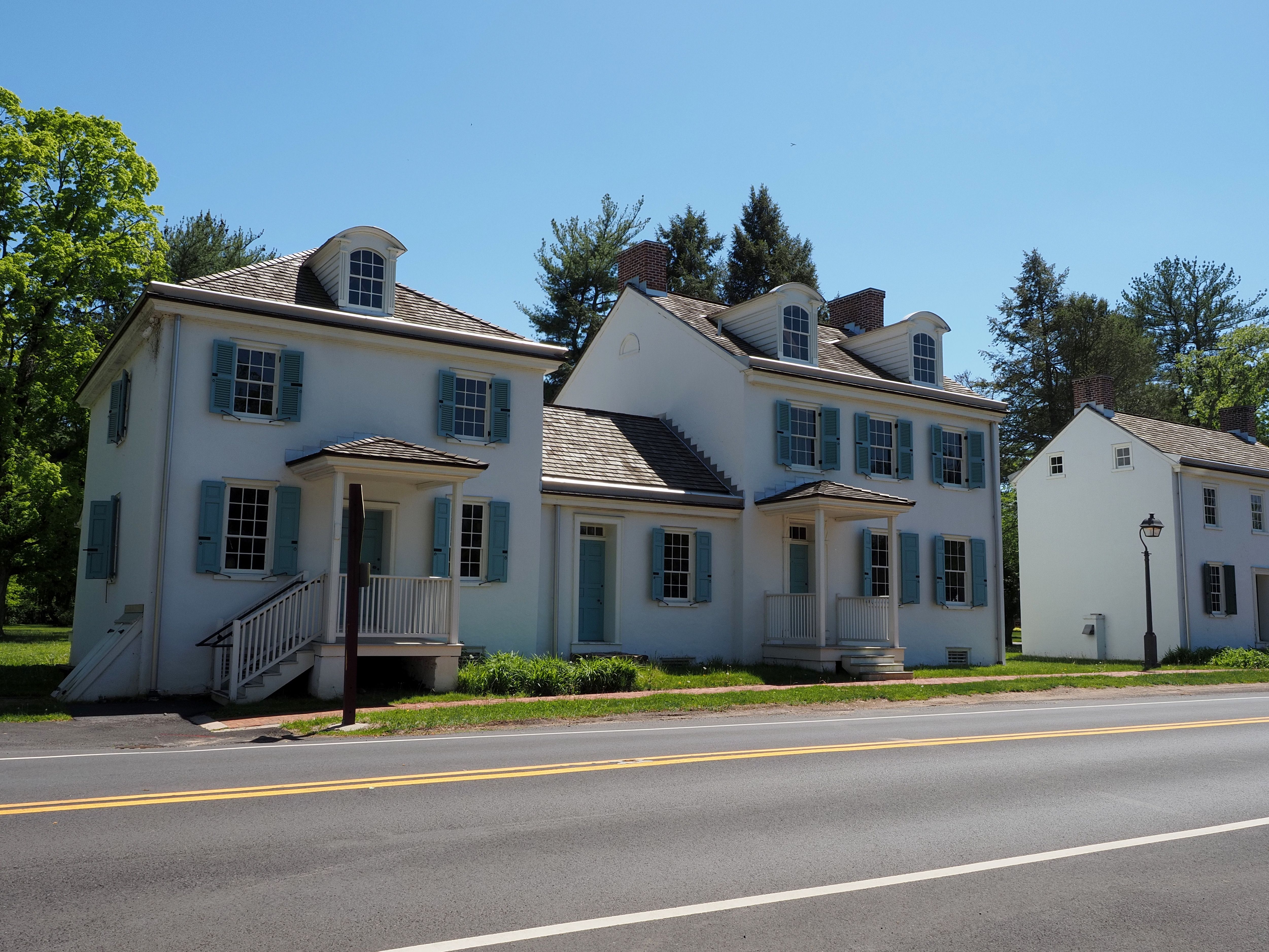 Row of historic colonial homes on a sunny street in Washington Crossing, Pennsylvania