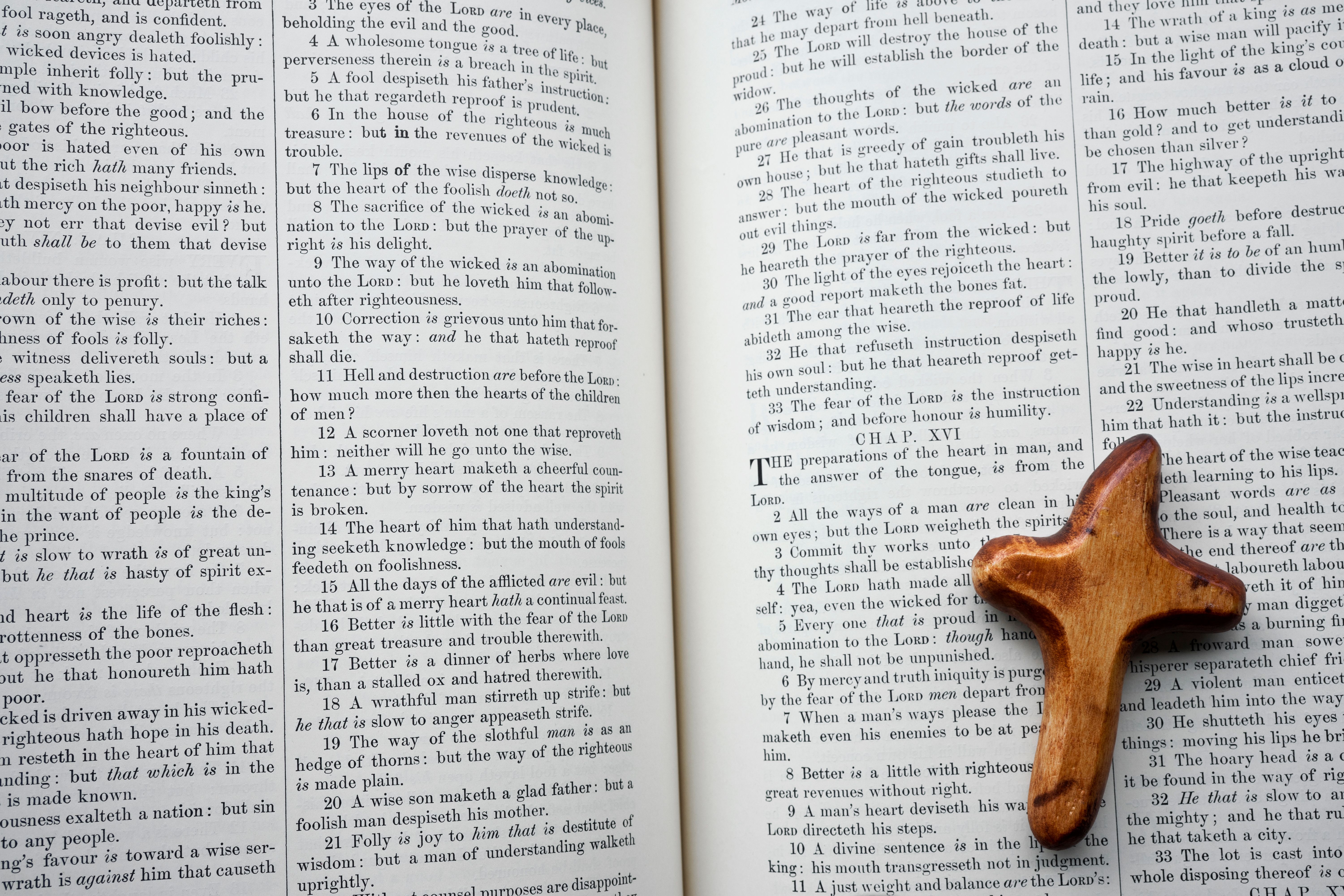 Wooden Cross on Open Bible with Scripture · Free Stock Photo