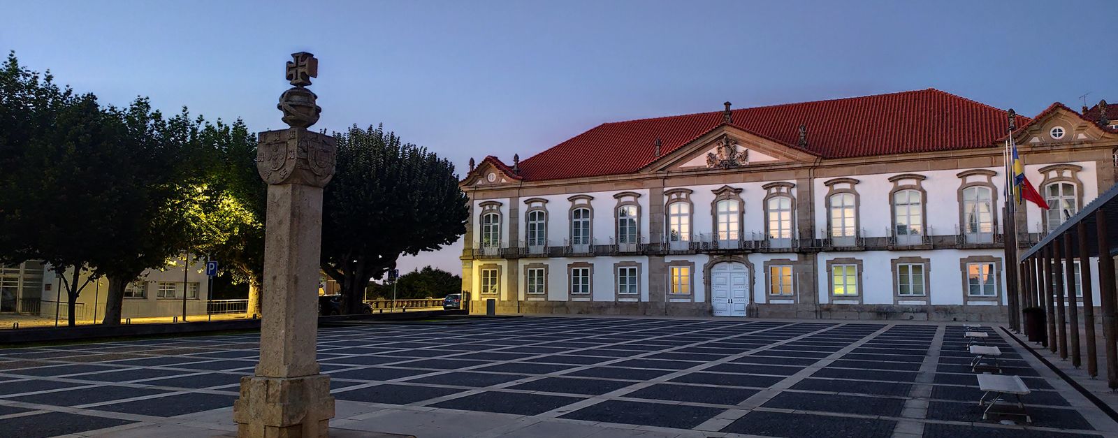 A serene view of a historic building and plaza in Seia, Portugal at dusk.