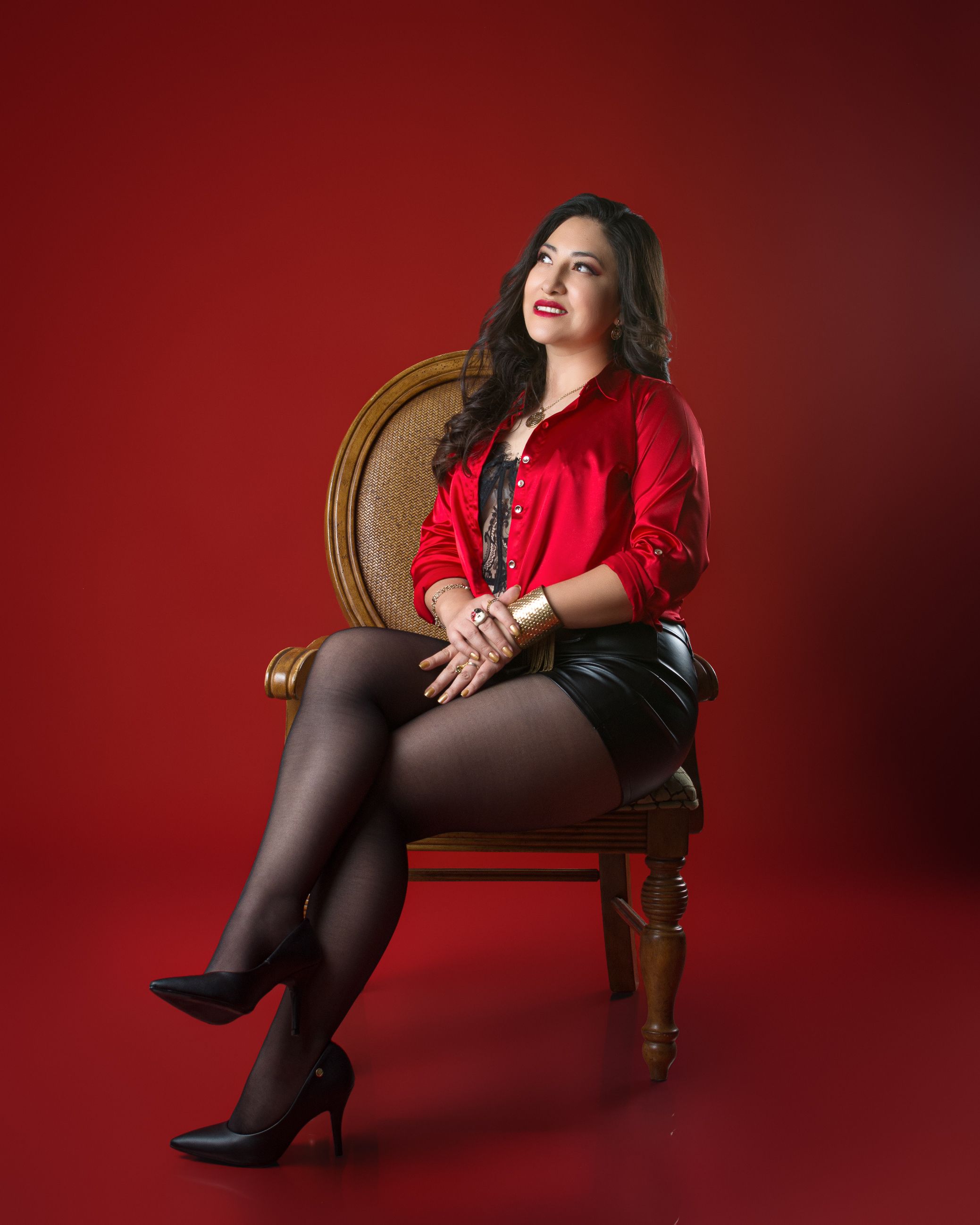 Elegant Woman in Red Outfit Sitting on Chair · Free Stock Photo
