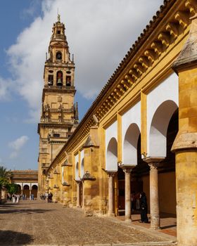 View of the iconic Mezquita-Cathedral with arched corridor and bell tower in Córdoba, Spain.