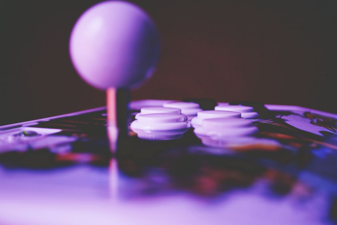 Free A vibrant close-up image of an arcade joystick and buttons, capturing a retro gaming mood. Stock Photo