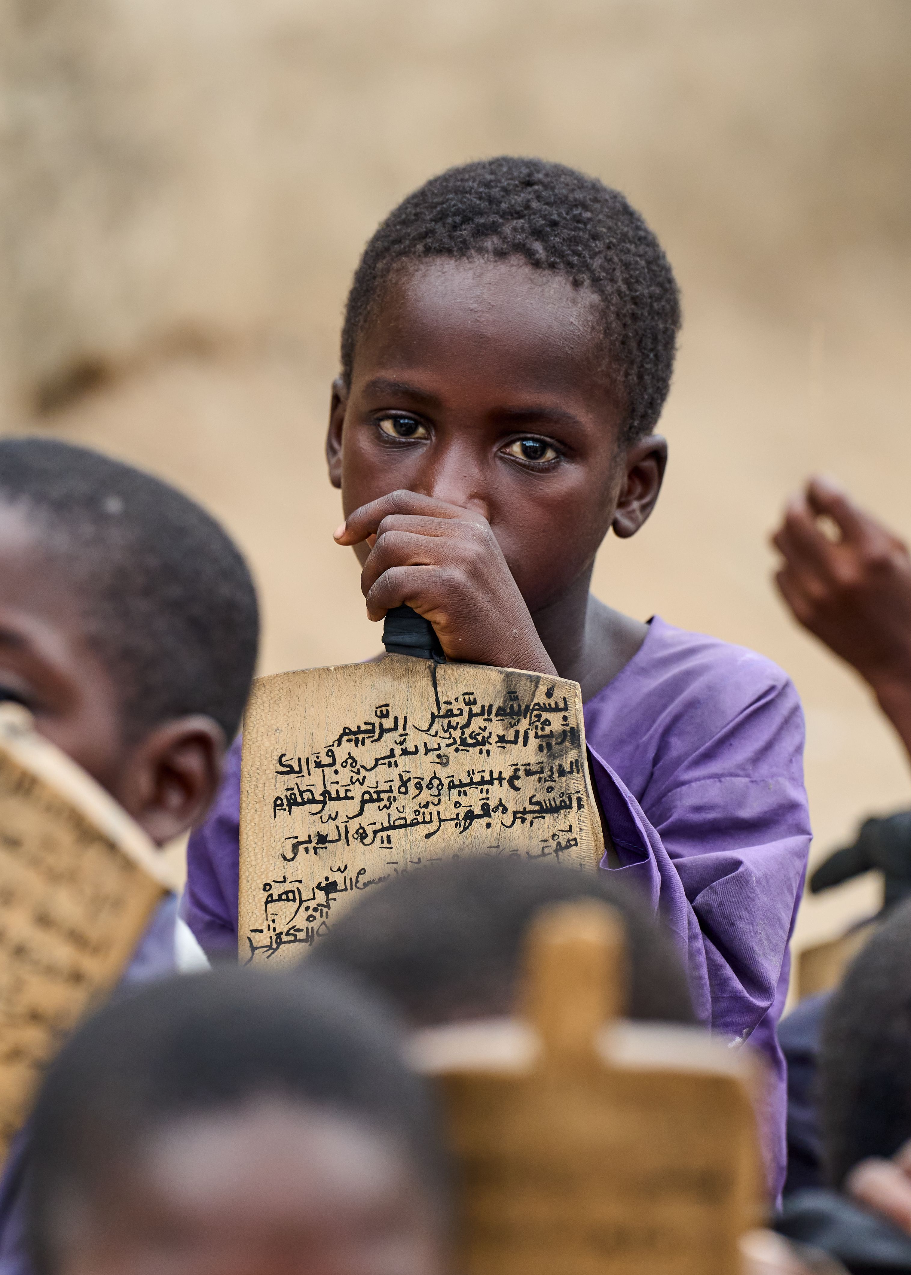 Child Holding Quranic Tablet in Classroom Setting · Free Stock Photo