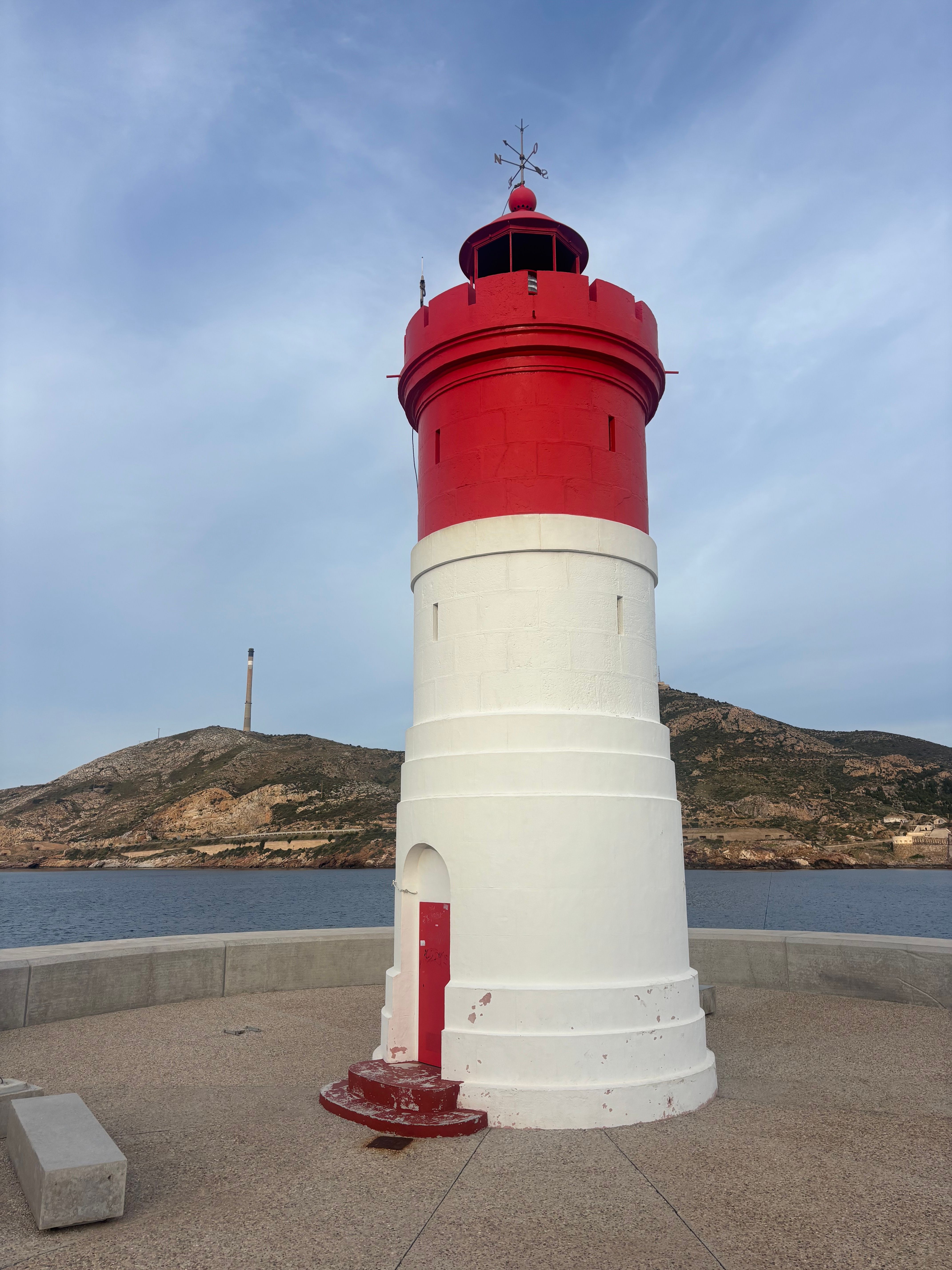 White and Red Lighthouse on Coastal Promenade