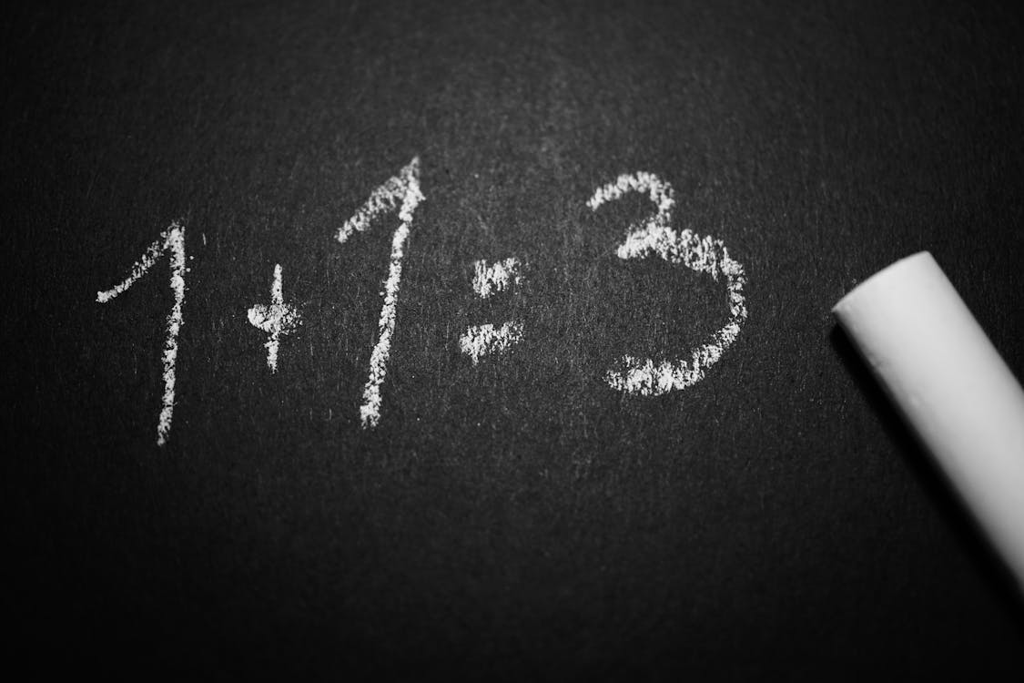 Free 1 + 1 = 3 Text on Black Chalkboard Stock Photo