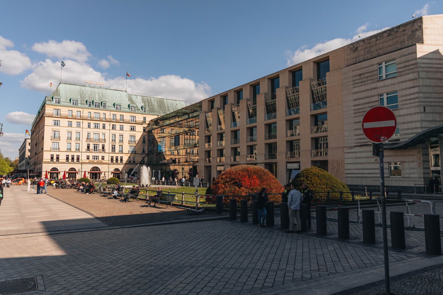 Urban scene of the historic Hotel Adlon in Berlin with vibrant city life and architecture.