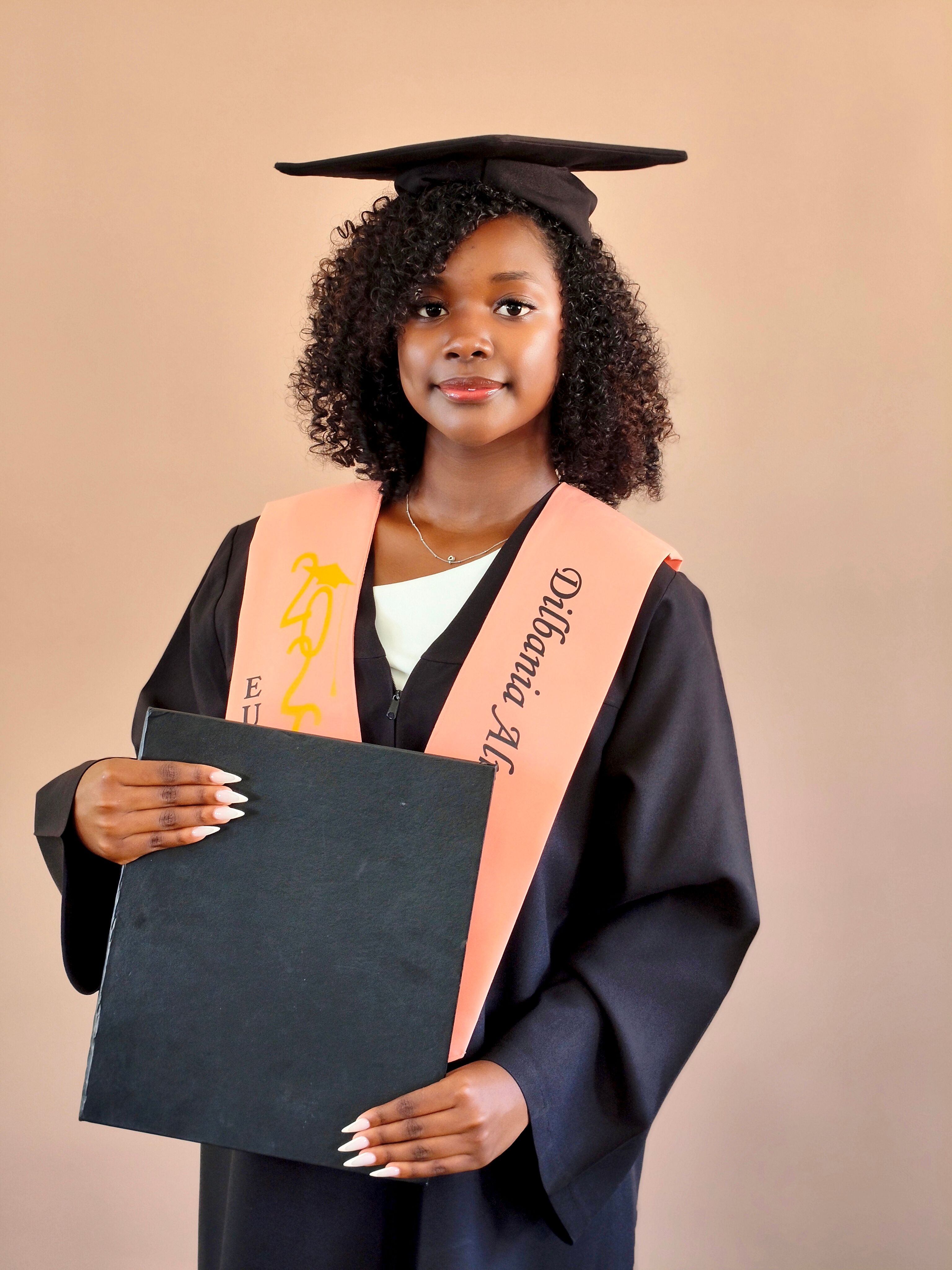 Young graduate in cap and gown holding diploma, symbolizing achievement and new beginnings.