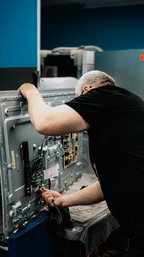 Technician repairing a Frigidaire brand appliance