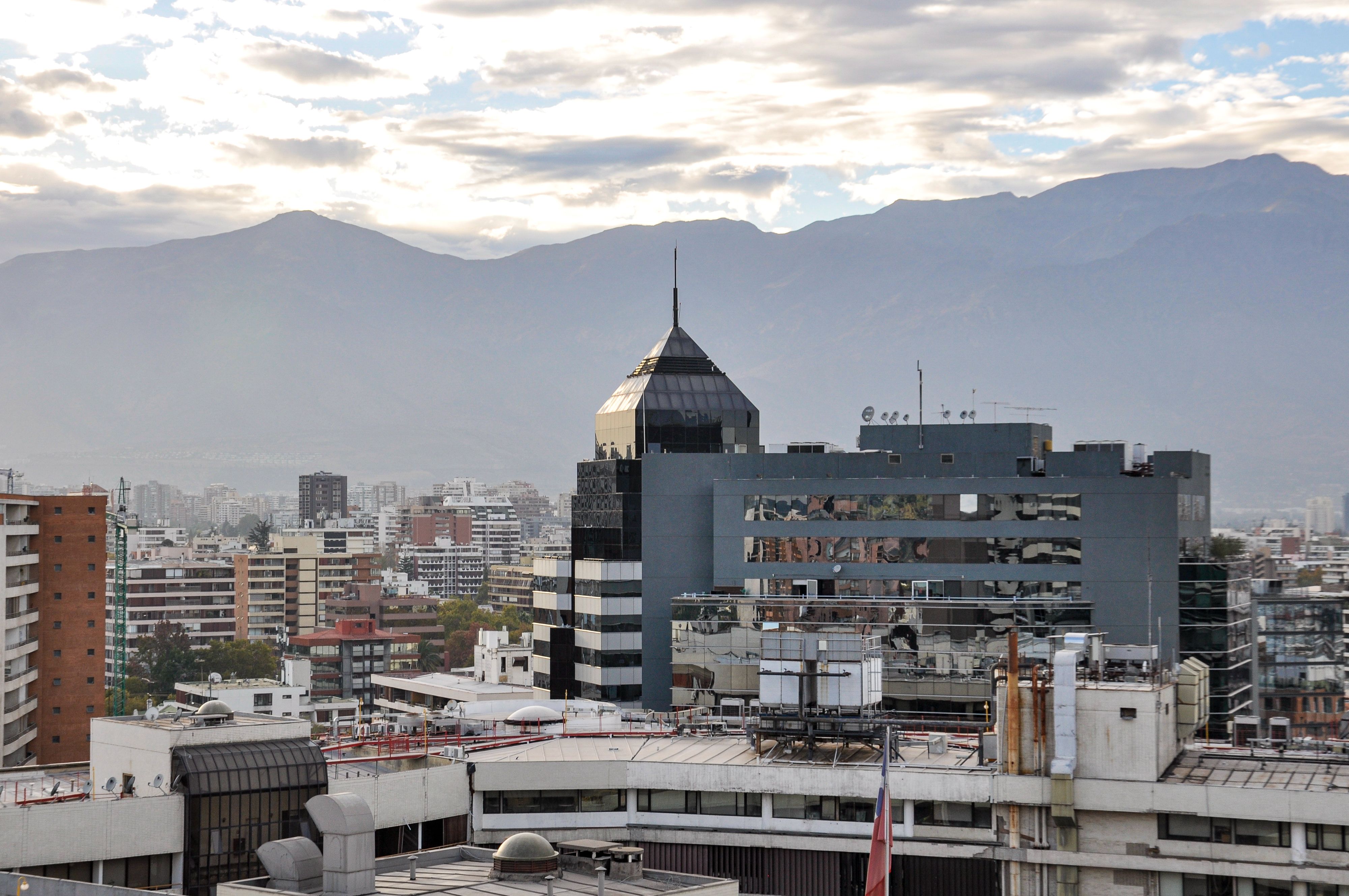 View of Santiago cityscape with Andes mountains in the background, showcasing modern architecture.