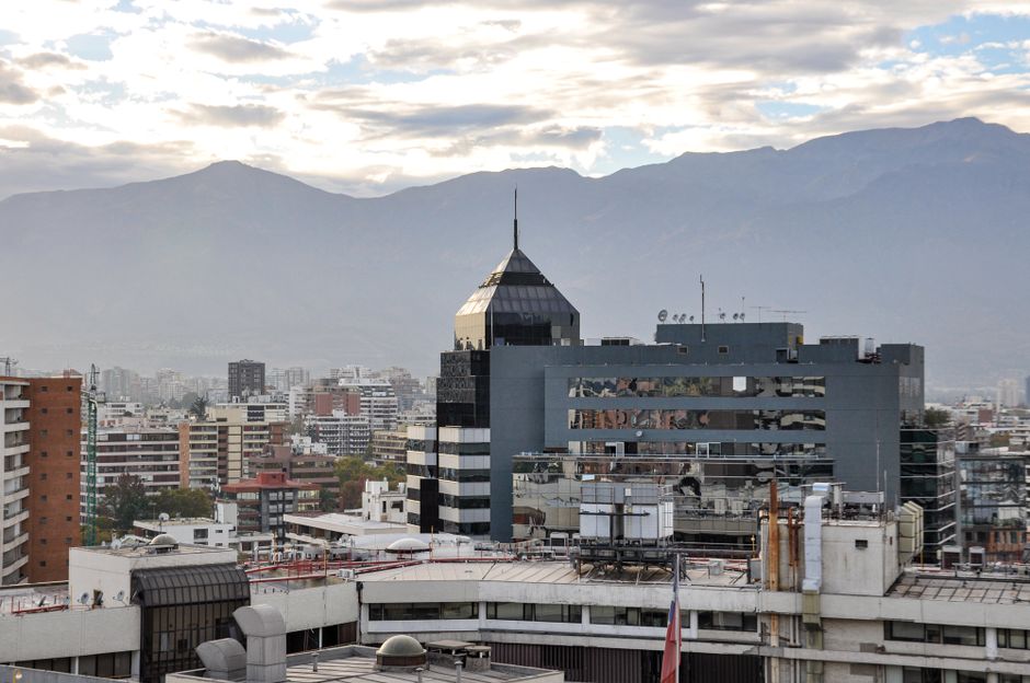 View of Santiago cityscape with Andes mountains in the background, showcasing modern architecture.