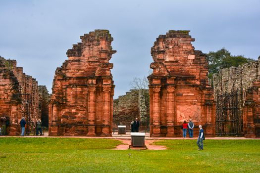 Tourists exploring ancient stone ruins in Misiones, Argentina's heritage site.