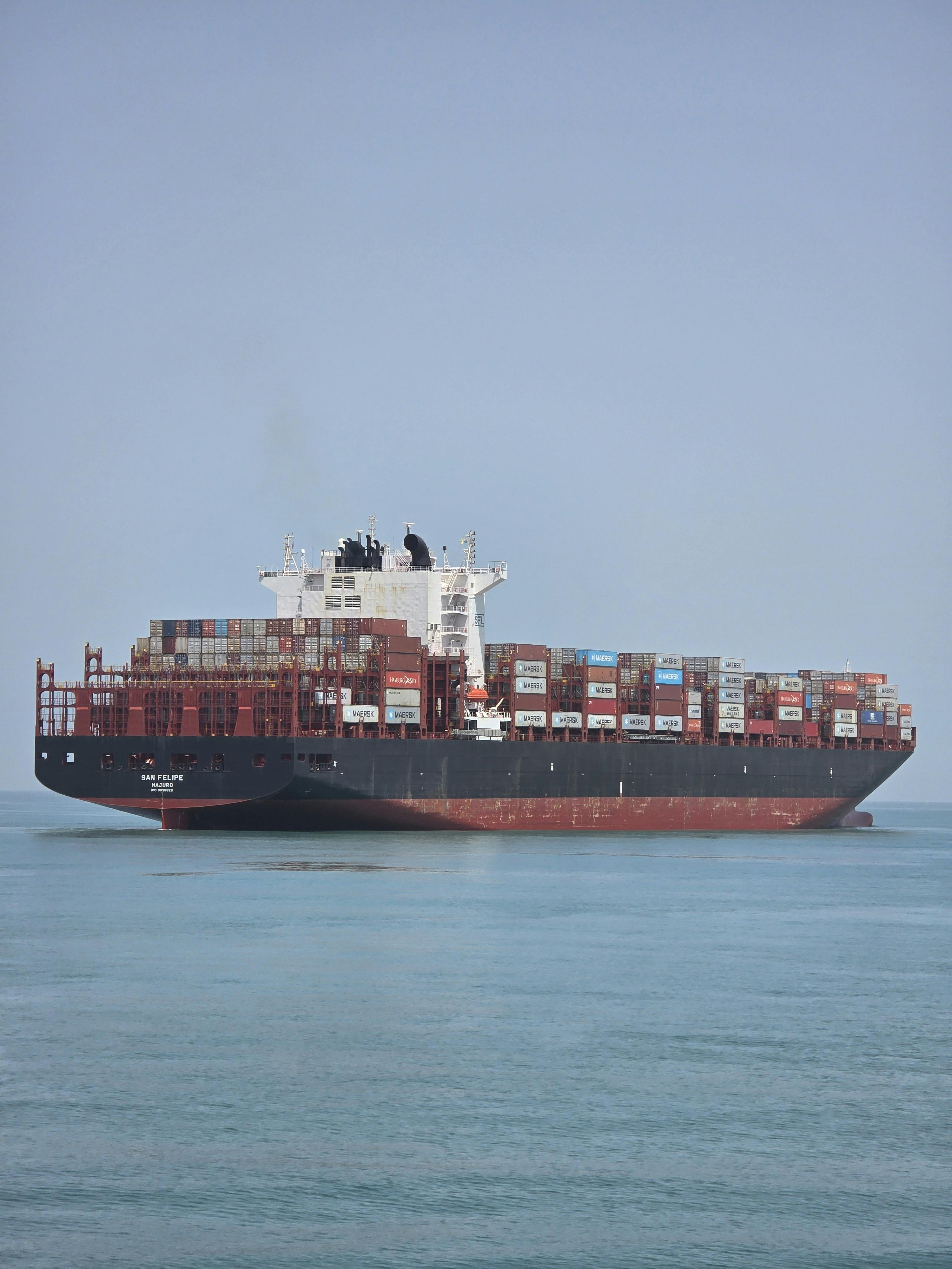 A large container ship sails through South African waters loaded with cargo.