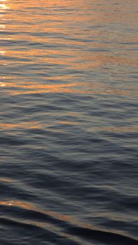 Gentle ocean waves illuminated by a warm sunset glow in Güney Afrika, creating a peaceful ambiance.