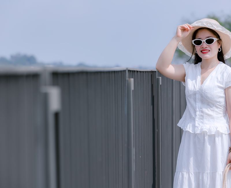 A stylish summer outfit featuring lightweight fabrics and accessories in a sunny park