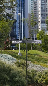 Viewing lush greenery and modern architecture in La Mexicana Park, Mexico City.