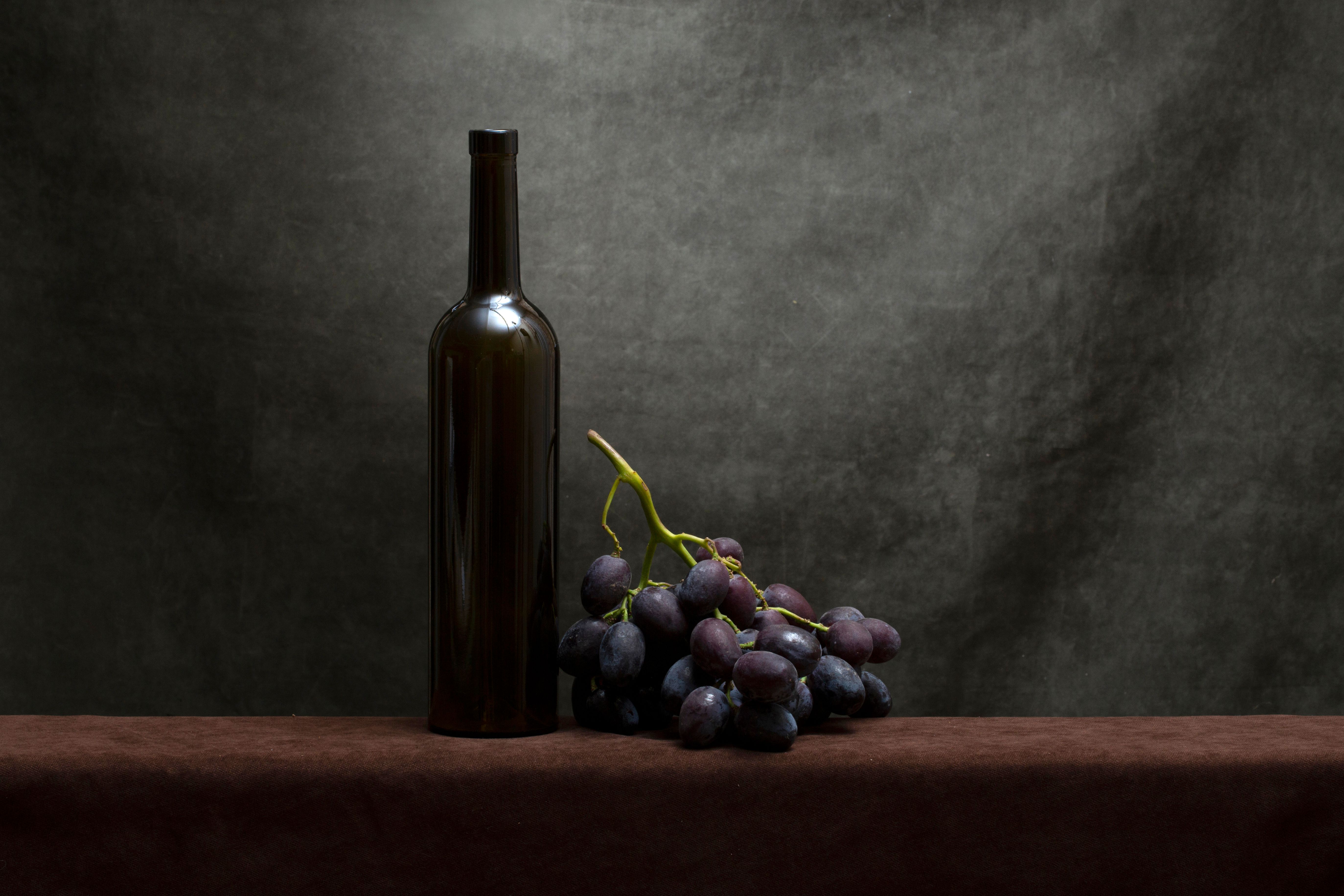 Elegant Still Life of Wine Bottle and Grapes · Free Stock Photo