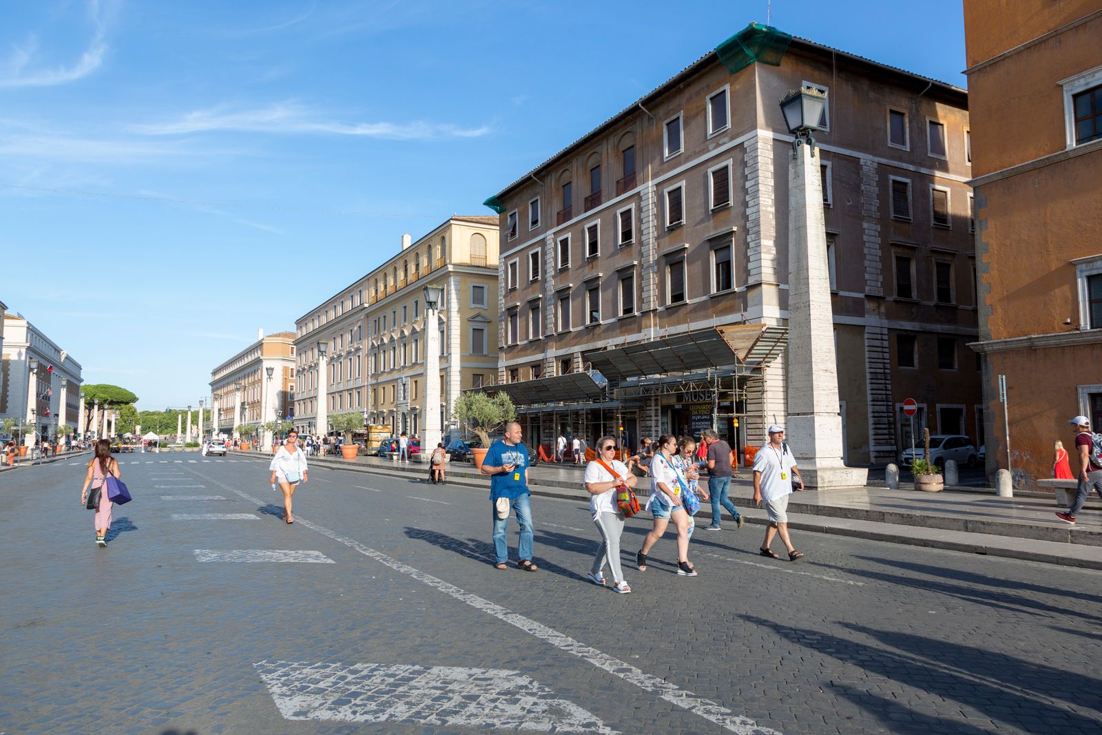 A tram moving through a Rome street lined with old buildings