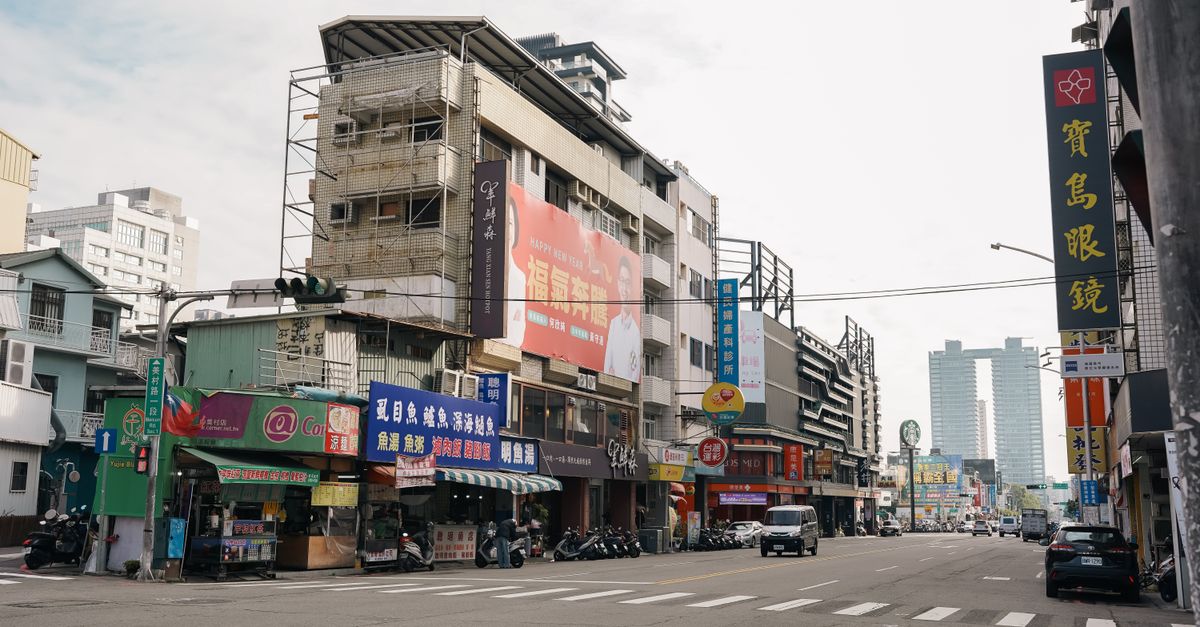 Dynamic urban street view in Taichung City, Taiwan featuring colorful signage and bustling activity.