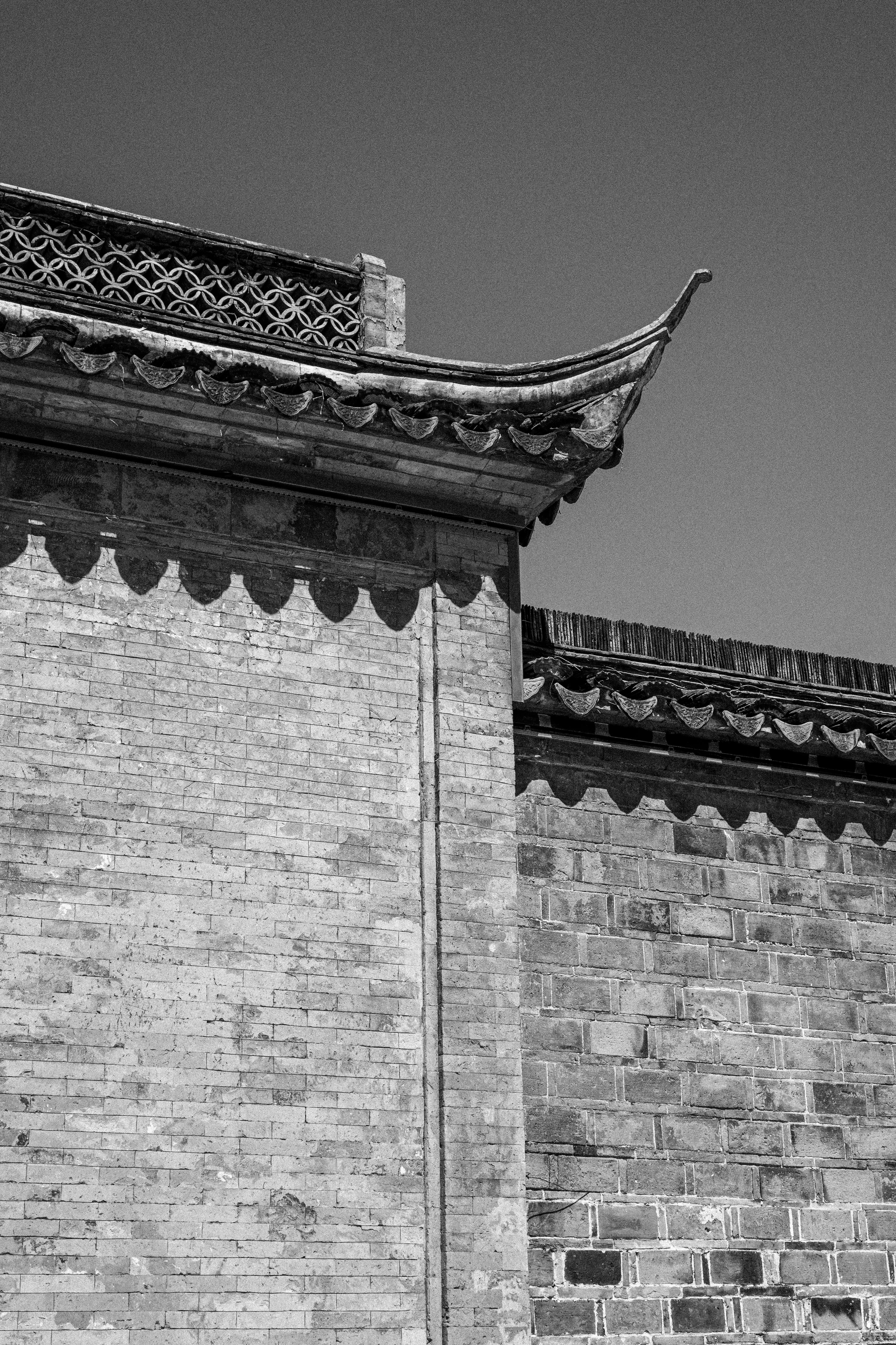 Black and white photo of traditional Chinese roof architecture in Nanjing, China.