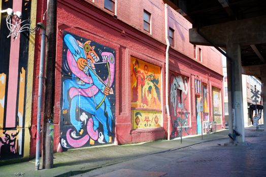 Vibrant murals on an urban building wall in Portland, Oregon, showcasing artistic street art.