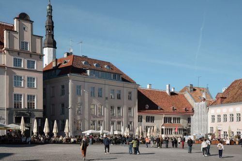 Free A vibrant scene of Tallinn's historic Raekoja plats with people enjoying the sunny day. Stock Photo