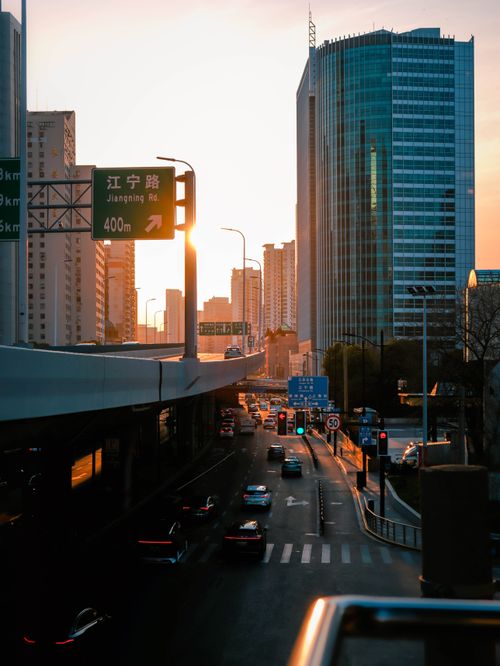 Free Scenic view of a busy urban expressway during sunset with modern skyscrapers and traffic. Stock Photo