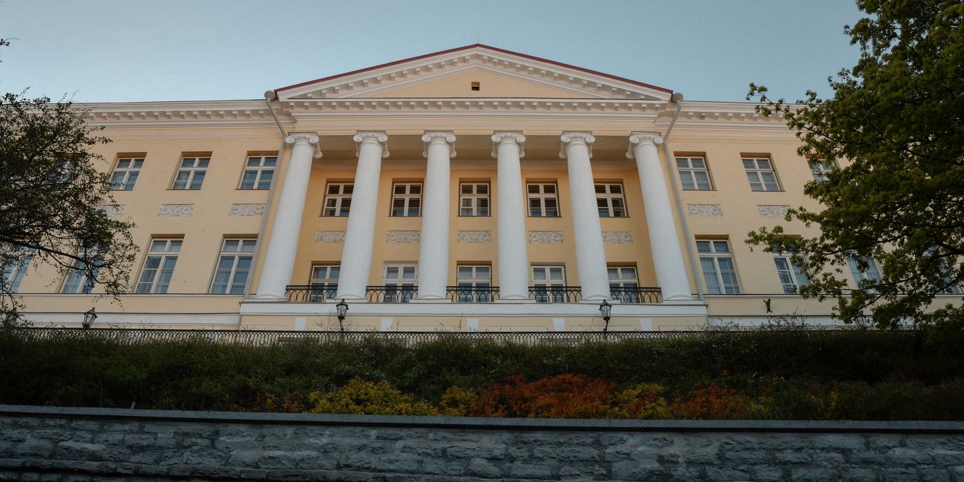 Historic Stenbock House, a neoclassical gem in Tallinn, Estonia, under clear autumn skies.