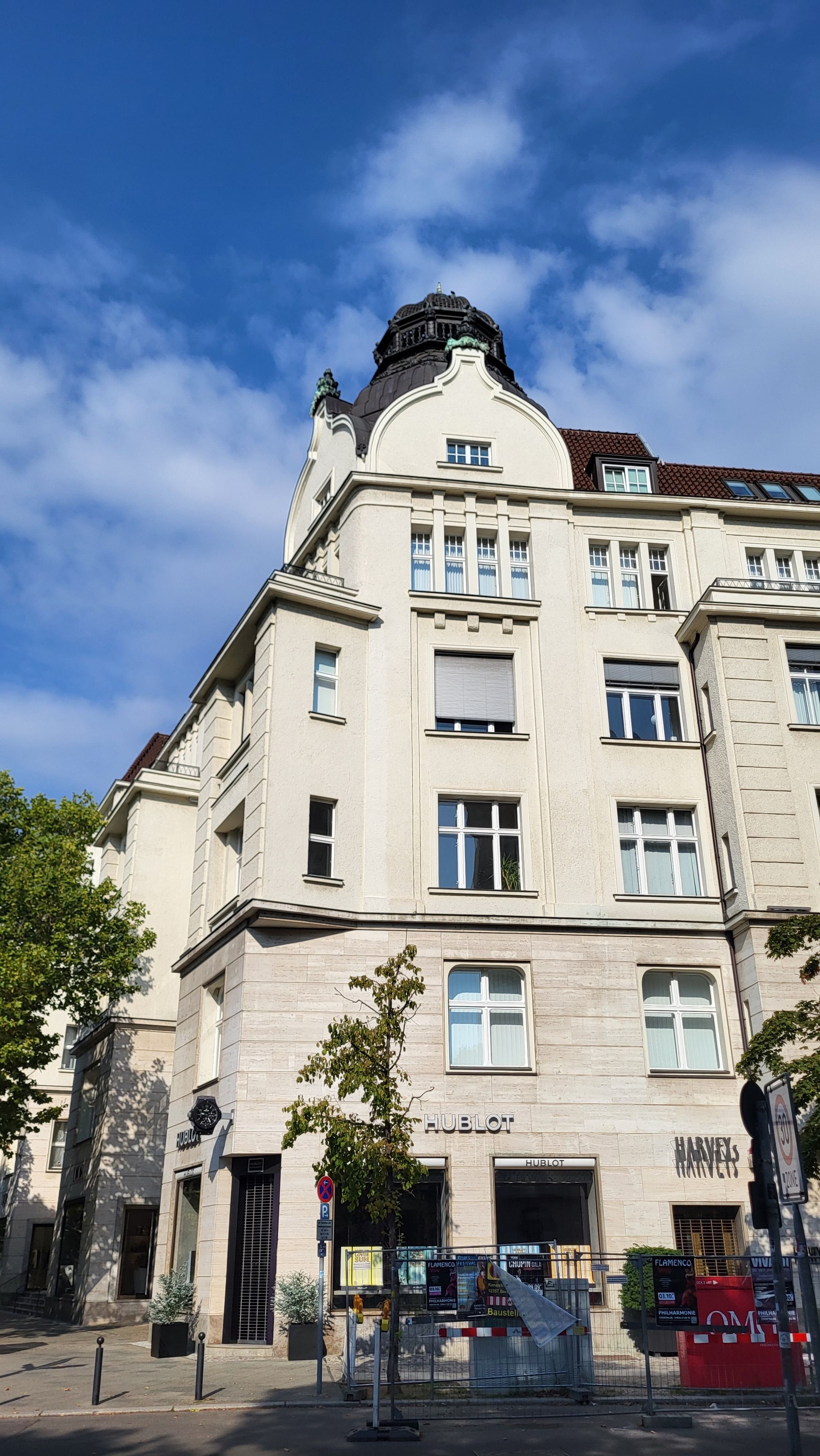 Charming historic building in Berlin, Germany against a bright blue sky. Captivating architecture and city vibe.