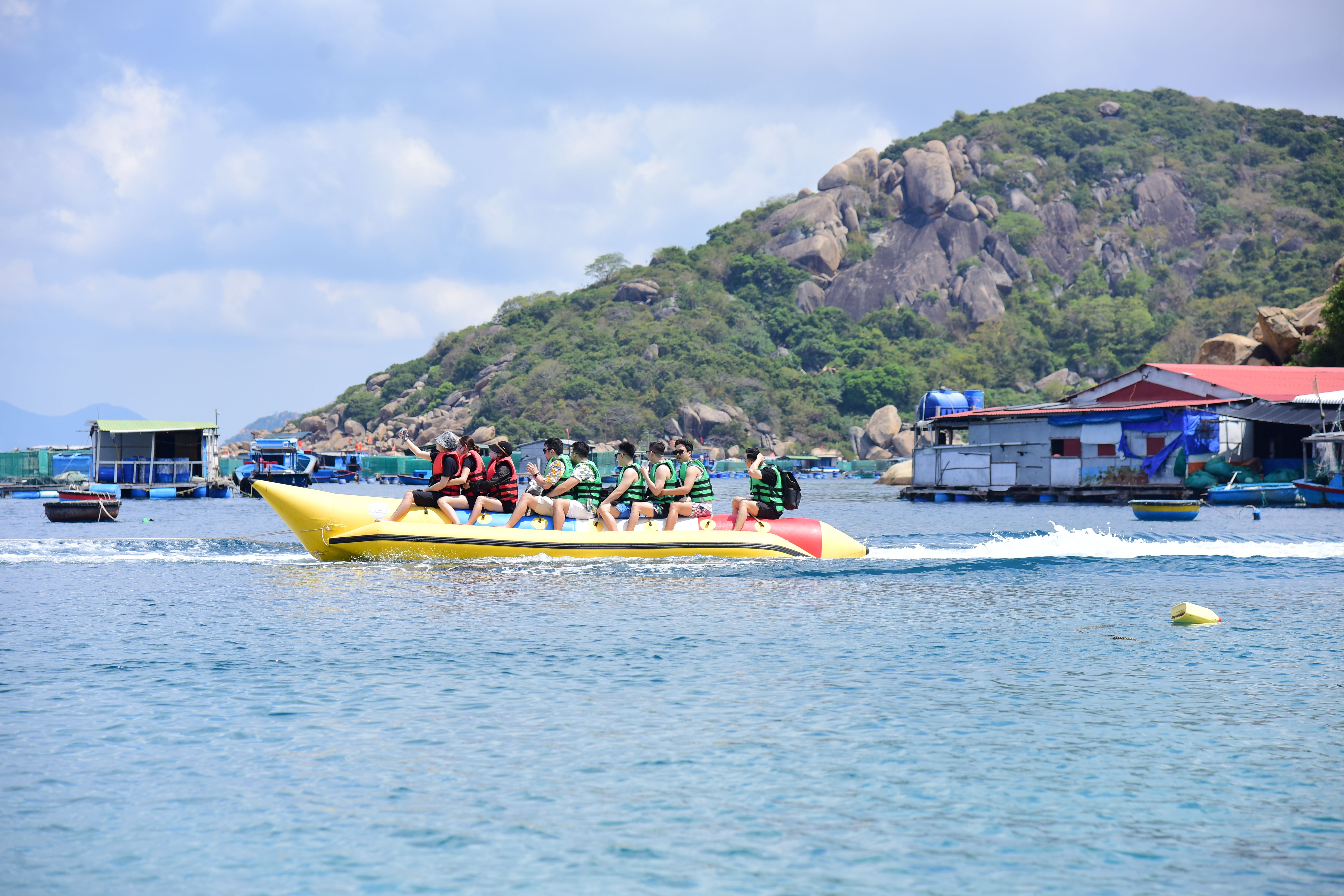 Group Enjoying Banana Boat Ride on Scenic Lake · Free Stock Photo