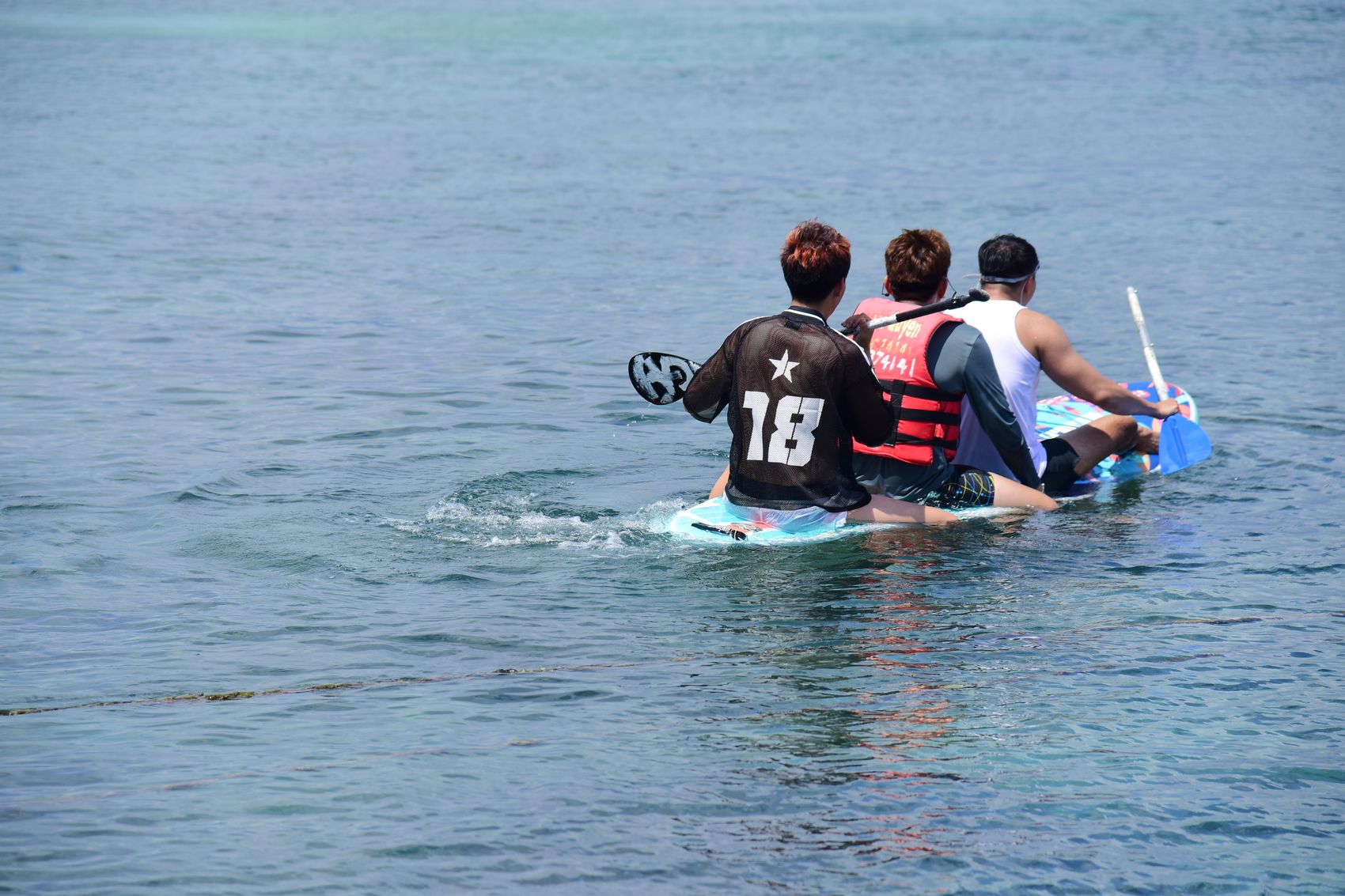 Group kayaking together on open water