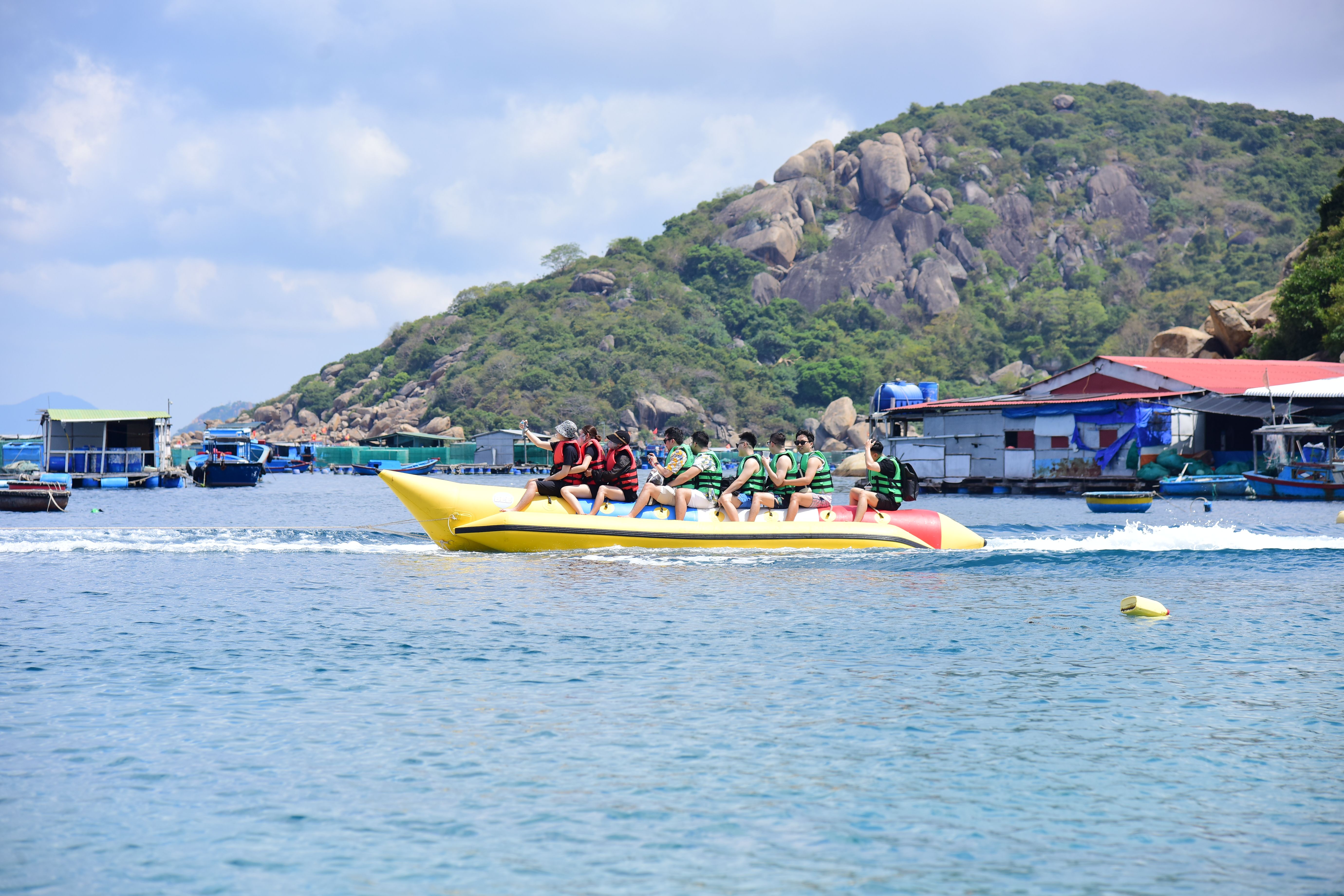 Tourists Enjoying Banana Boat Ride on Tropical Beach · Free Stock Photo