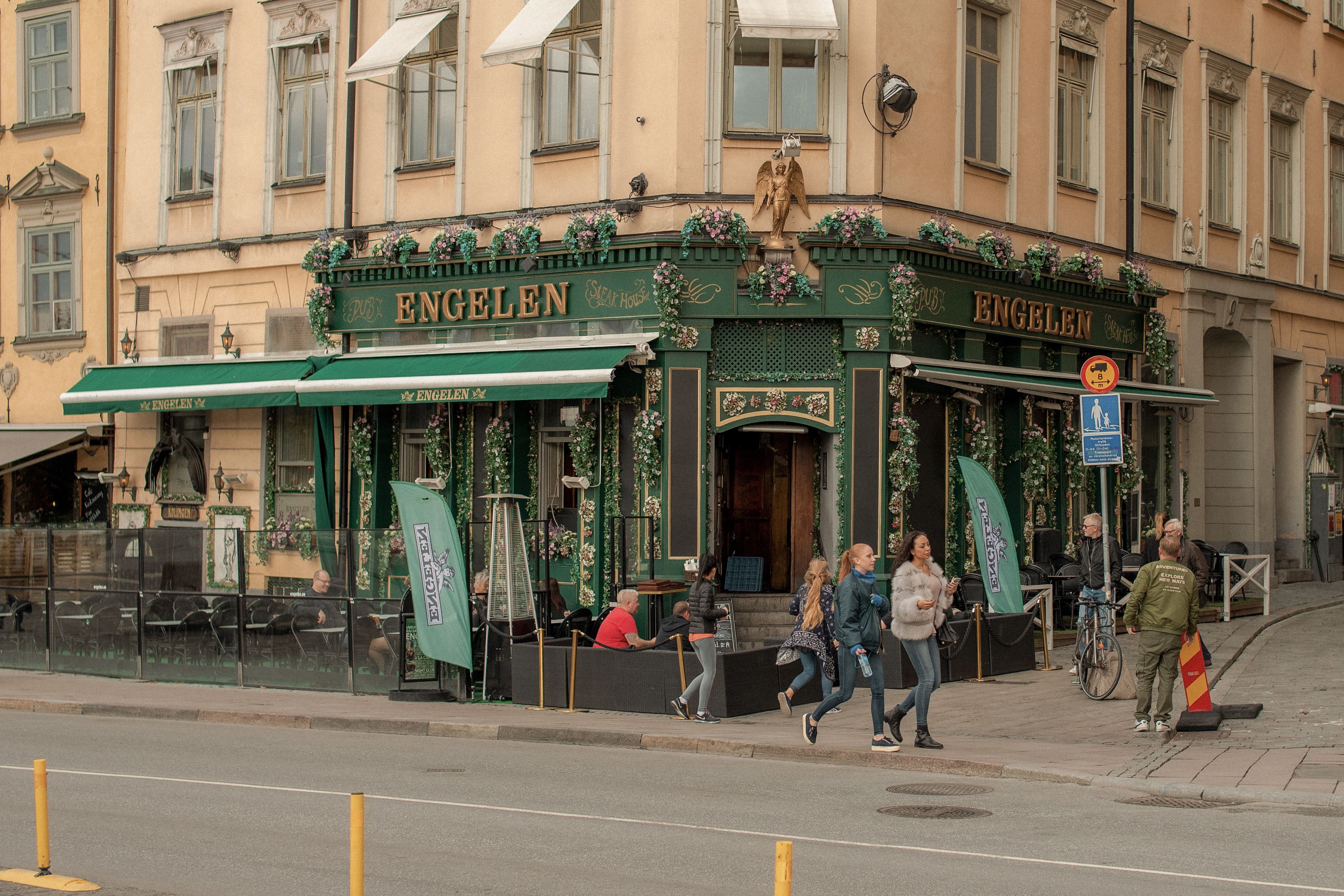 Bustling street scene outside Engelen pub, Stockholm's vibrant Old Town.