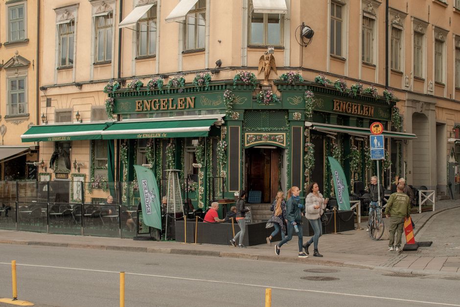 Bustling street scene outside Engelen pub, Stockholm's vibrant Old Town.